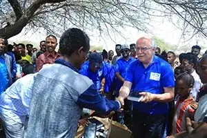 Hand in Hand Partnership Handing Out Bibles